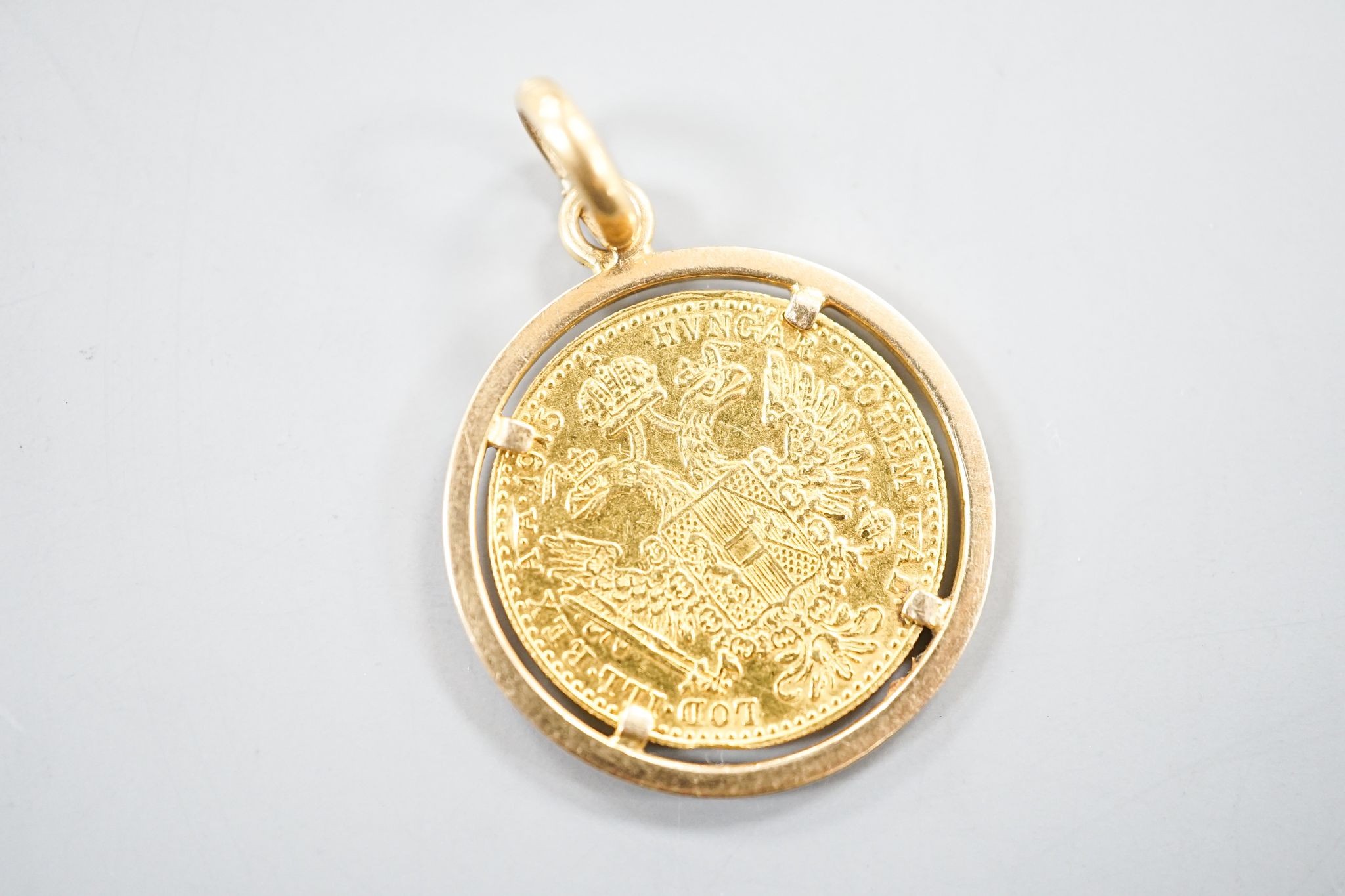 An Austrian 1915 gold ducat re-strike?, on a 750 yellow metal pendant mount, gross 6.2 grams.